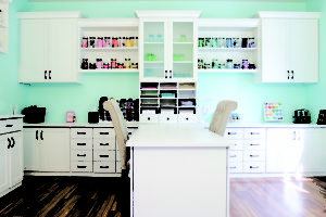 White Craft Room with Shelving Drawers Counter Space Cabinets Frosted Glass Display Doors and Built in Desk