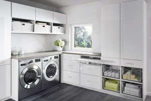 Laundry Room Storage with White Shelving Cabinets and Counter Top Metal and Wicker Baskets and Pull Out Ironing Board